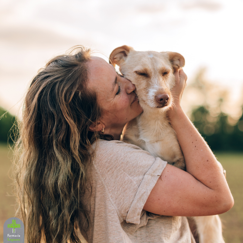 Ragazza che abbraccia e bacia il proprio cane, immagine dedicata alla Giornata Mondiale del Cane e alla cura del suo benessere